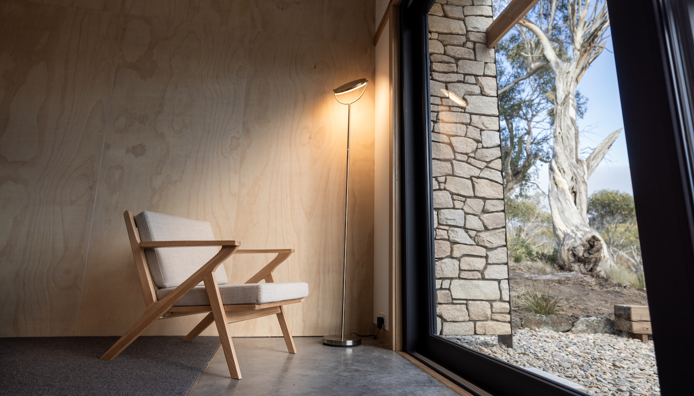 Reading chair and views in a romantic cabin in the Snowy Mountains