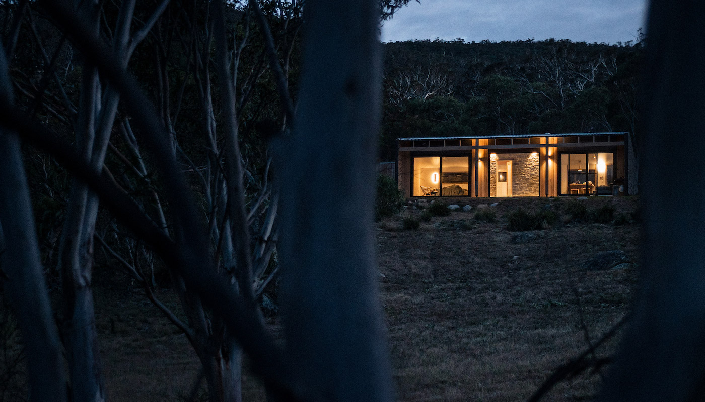 A romantic cabin in the Snowy Mountains at dusk